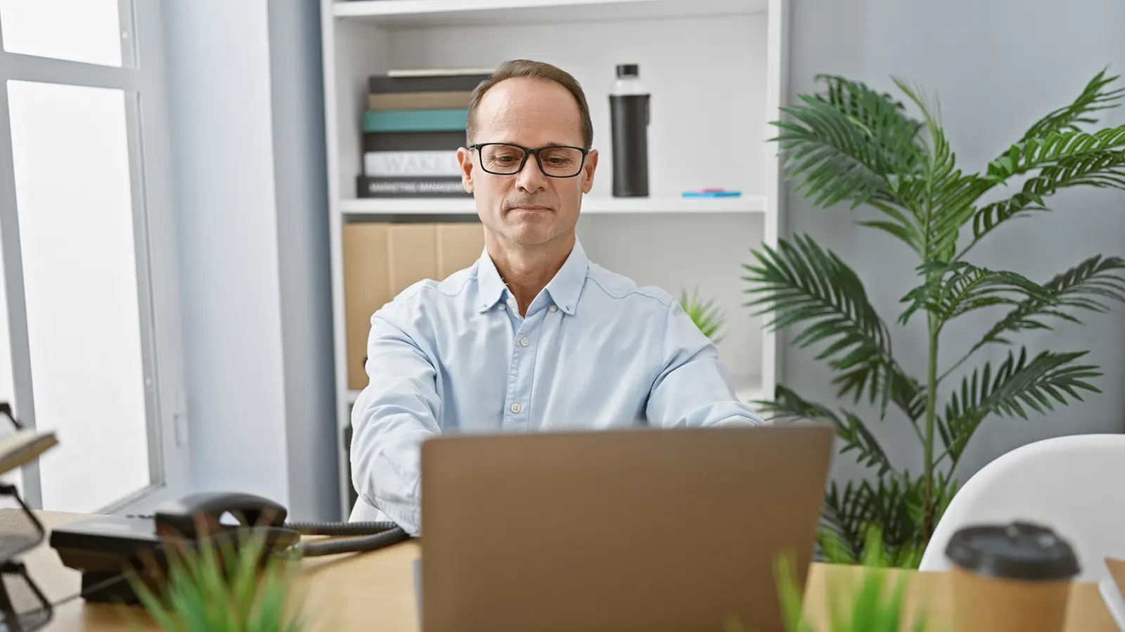 Image of a business person working at a laptop.