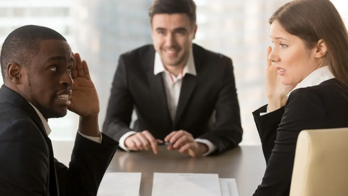 Two business employees interviewing a future boss looking doubtful.